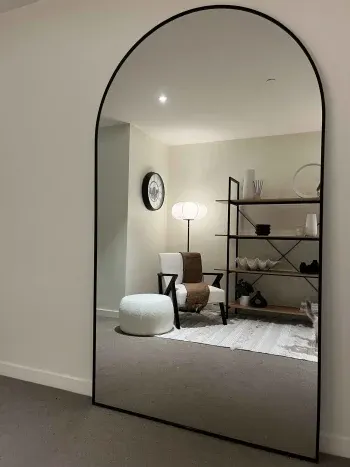 Oversized black-framed arch-top mirror — The Executive